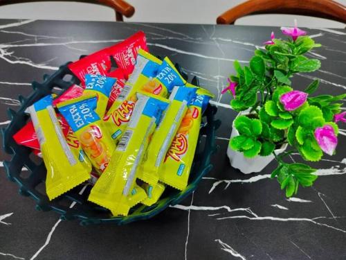 a basket of lays chips on a table with a plant at Lakeview 3 Bedroom Apartment in Presint 18 Putrajaya in Putrajaya