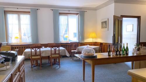 a dining room with tables and chairs and windows at Landgasthof Rebstock Weil am Rhein / Basel in Weil am Rhein