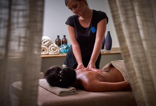 a woman getting a massage from a therapist at Alas Resort & Spa in Elia Laconias