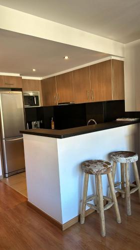 a kitchen with a counter and two stools at Appartement au coeur d'Ordino HUT7872 in Ordino