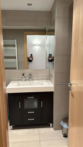 a bathroom with a sink and a mirror at Appartement au coeur d'Ordino HUT7872 in Ordino