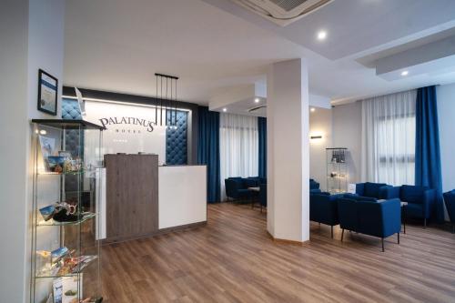 a salon with a waiting room with blue chairs at Hotel Palatinus in Sopron