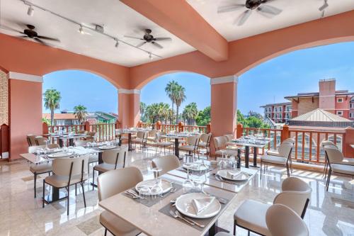 a restaurant with tables and chairs on a patio at Megasaray Club Belek in Belek