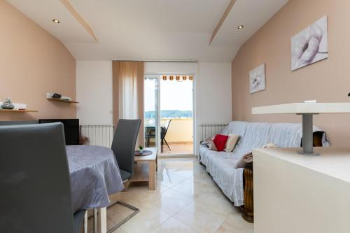 a living room with a couch and a table at Apartments Sabina in Supetarska Draga