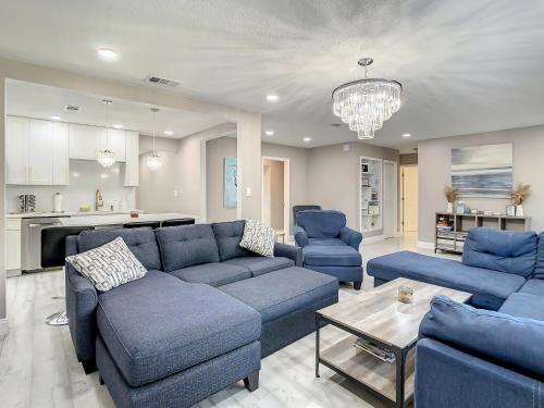 a living room with a blue couch and blue chairs at AMI, IMG, Dogsitting, Boats, Snorkeling, Fishing, Beach, Bikes, Golf, Hottub, BBQ, SRQ in Bradenton