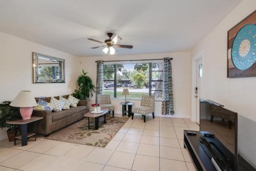 a living room with a couch and a ceiling fan at 3 bedroom House with Renovated kitchen and bath! in Cocoa