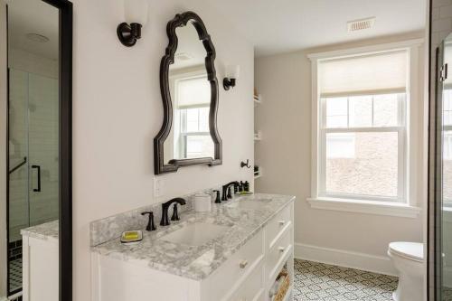 a white bathroom with a sink and a mirror at Shurs Lane Cottage, EV Charging, Free Parking in Philadelphia