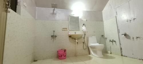 a bathroom with a toilet and a sink at Dutch Square Hostel in Alleppey