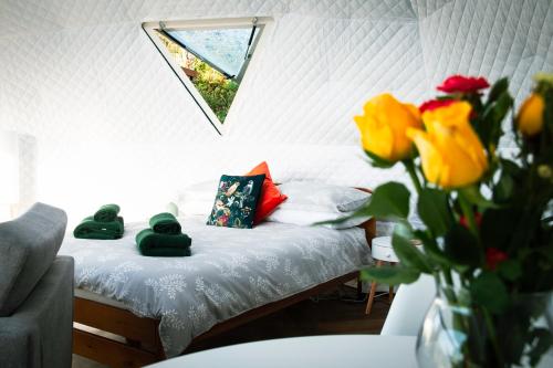 a small bedroom with a bed with towels on it at Sunset Ridge - Luxury Geodesic Dome set in the beautiful countryside in Porkellis