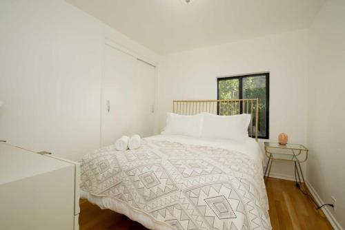 a white bedroom with a bed and a window at Hillside Artist Retreat 3BR - Hills of Eagle Rock in Los Angeles