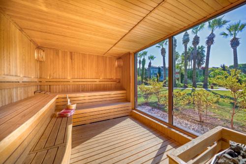 a sauna with a view of the palm trees at Megasaray Club Belek in Belek