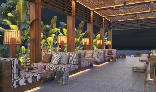 a lobby with couches and tables and plants at Megasaray Club Belek in Belek