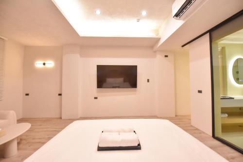 a large white room with a skylight at Two Couples Leisure Art Motel in Tainan