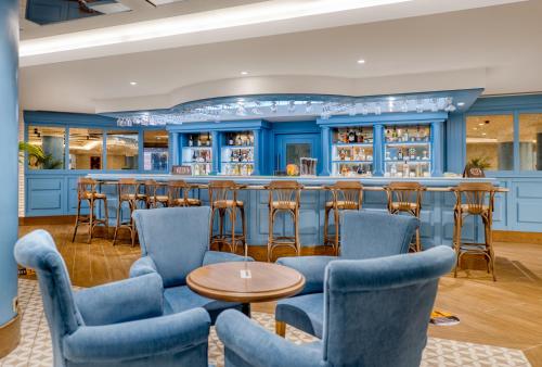 a bar in a restaurant with blue walls and stools at Megasaray Club Belek in Belek