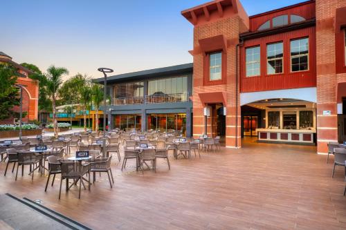 a courtyard with tables and chairs in front of a building at Megasaray Club Belek in Belek