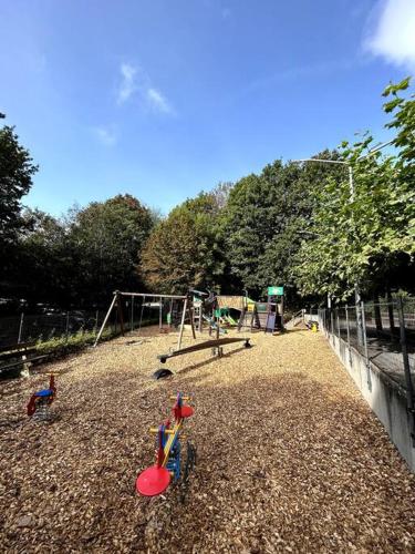 a park with a playground with a swing set at Chaleureux chalet à Durbuy in Durbuy