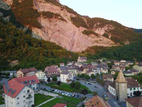 a small town in front of a mountain at Appartement Les Salines in Roche