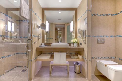 a bathroom with a sink and a toilet and a tub at Megasaray Club Belek in Belek