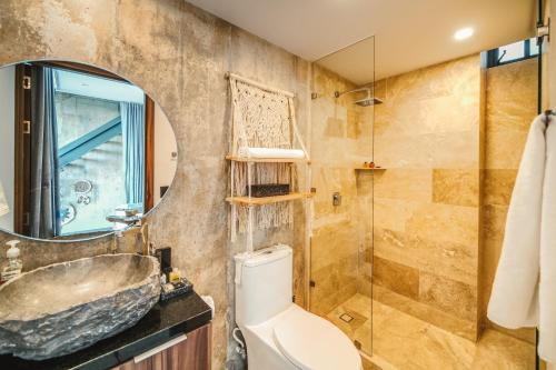 a bathroom with a sink and a toilet and a mirror at Tulum Paradise - Penthouse with Private Pool and Cenote in Tulum
