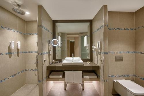 a bathroom with a sink and a mirror at Megasaray Club Belek in Belek