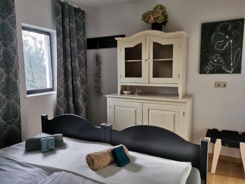 a bedroom with a bed and a medicine cabinet at Seepark Weiden - Baumhof in Weiden am See