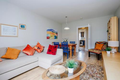 a living room with a couch and a table at Edinburgh Central 2-Bedroom Old Town Apartment in Edinburgh