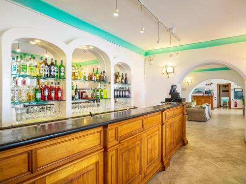 a bar with a lot of alcohol bottles at Hotel Ossidiana Stromboli Center in Stromboli