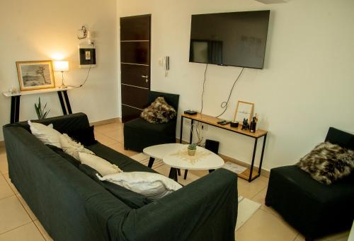 Sala de estar con 2 sofás y mesa en Leguizamon Apart en Salta