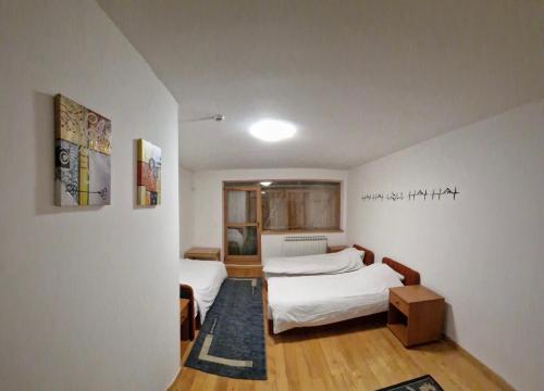 a small room with two beds in it at BJELAŠNICA BEX APARTMANI in Bjelašnica
