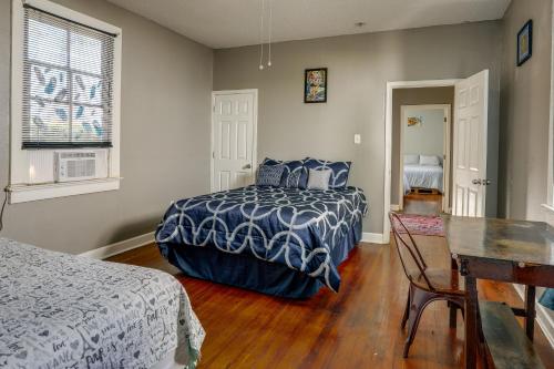 a bedroom with a bed and a desk and a table at New Orleans Home about 2 Mi to French Quarter! in New Orleans