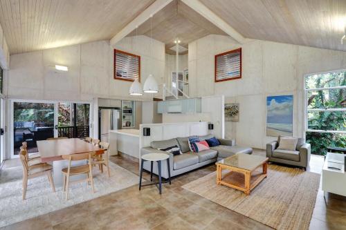 a living room with a couch and a table at Billa Villa in Point Lookout