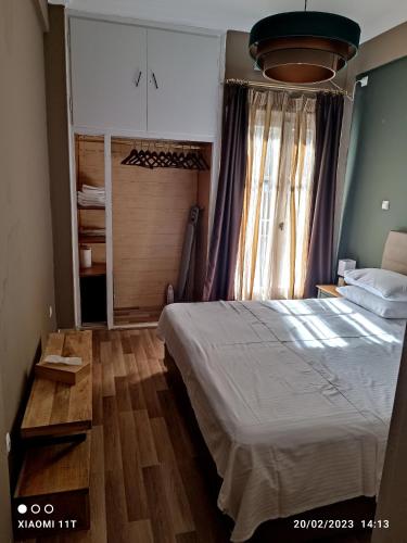 a bedroom with a bed and a large window at Ulysses Apartments Acropolis in Athens