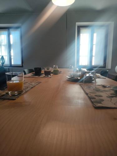 a long wooden table with glasses on top of it at Miravigne House - Casa di Campagna con Cucina in Castagnole Lanze