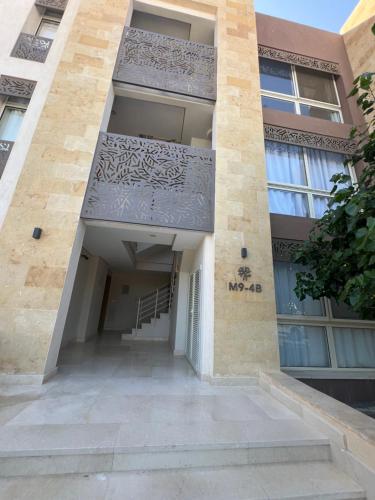 a building with a balcony on the side of it at Mangroovy Seafront condo - Great Kite Surfing in Hurghada
