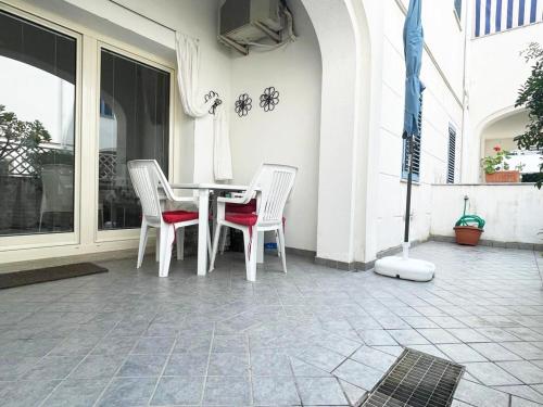 a white table and chairs on a patio at Le Residenze Blu Sardinia in La Caletta