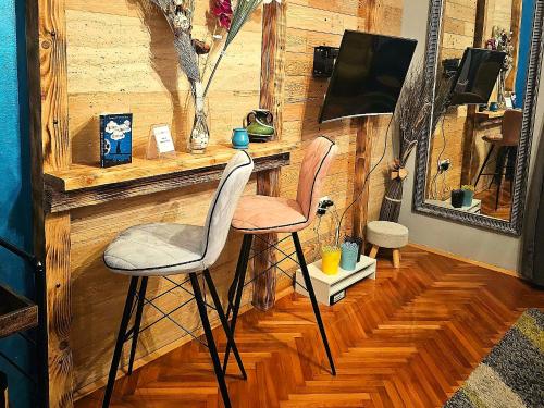 twee stoelen aan een bar in een kamer bij Apartman Marijana in Novi Sad