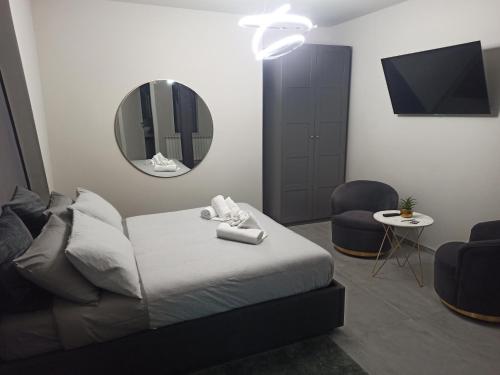 a bedroom with a bed and a mirror and a chair at Le Mirage in Chieti