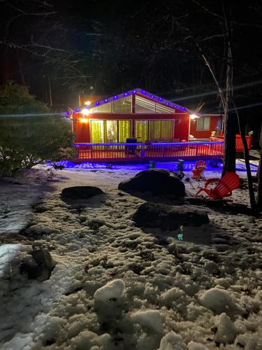 a house lit up in the snow at night at Pecosa home in Bushkill