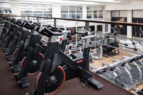 a row of exercise bikes in a gym at Delta Hotels by Marriott Heathrow Windsor in Windsor