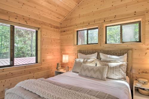 a bedroom with a bed in a wooden cabin at Spacious Cabin on Cross Lake Treehouse and Sauna! in Cross Lake