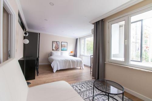 a bedroom with a bed and two windows at Spacious & Trendy 3BR Urban Home w/ ACs in Istanbul