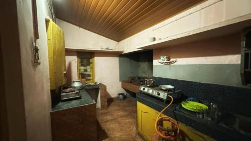 a kitchen with a stove and a counter top at Rose villa in Meenangadi