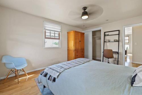 a bedroom with a large bed and a blue chair at Private, Quiet 2BR in Central Culver City Parking in Los Angeles