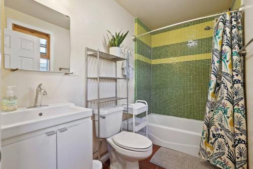 a bathroom with a toilet and a sink and a shower at Private, Quiet 2BR in Central Culver City Parking in Los Angeles