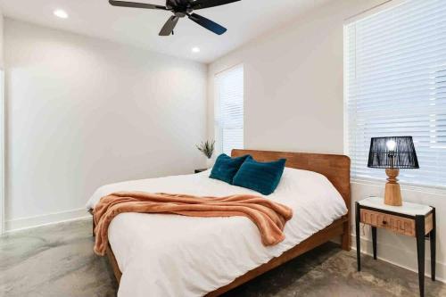 a bedroom with a bed and a ceiling fan at Jazz House*King Bed*Lux Matt*Coffee Bar in Lafayette