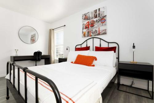 a bedroom with a black and white bed with red pillows at Centrally Located 2BR Home near LAX SoFi Stadium in Inglewood