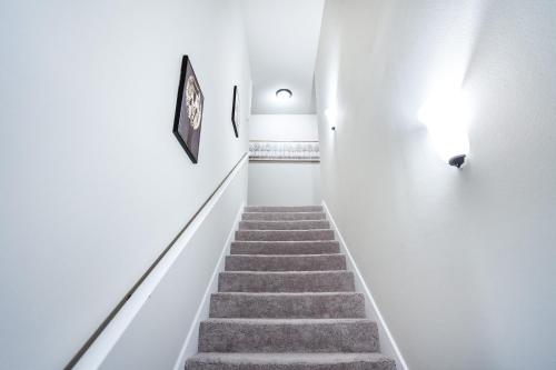 a stairway with white walls and a stair case at Winners Paradise next to LSU in Baton Rouge