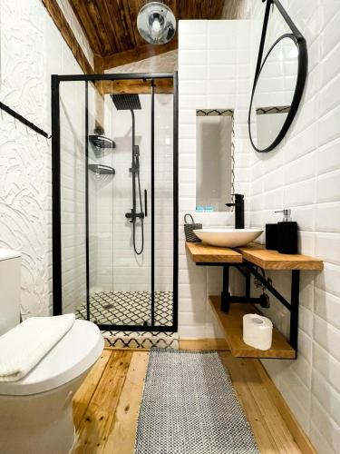 a bathroom with a shower and a toilet and a sink at Oasis Resort Lozenets in Lozenets