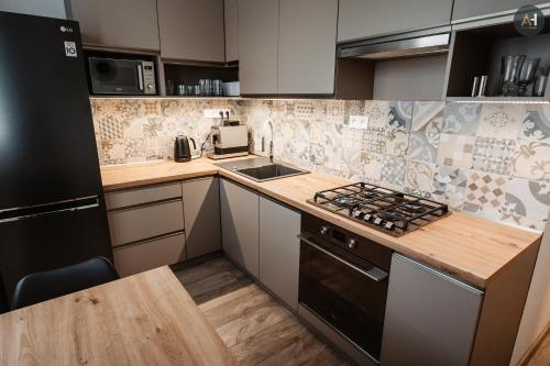 a kitchen with a counter top and a stove top oven at AH Lomená in Košice