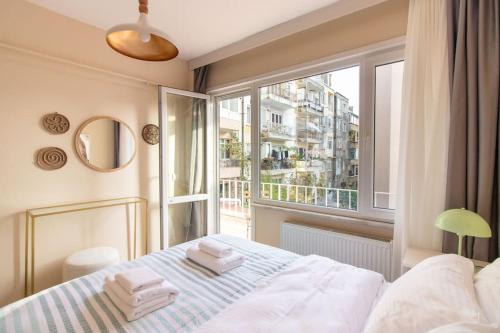 a bedroom with a bed and a large window at Cozy & Complete 1BR Retreat w/ Balcony in Istanbul